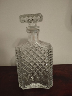 Glass whiskey bottle with embossed design and square stopper, 1980s