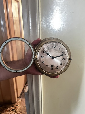 Vintage brass nautical ship clock, wall-mounted wind-up porthole style