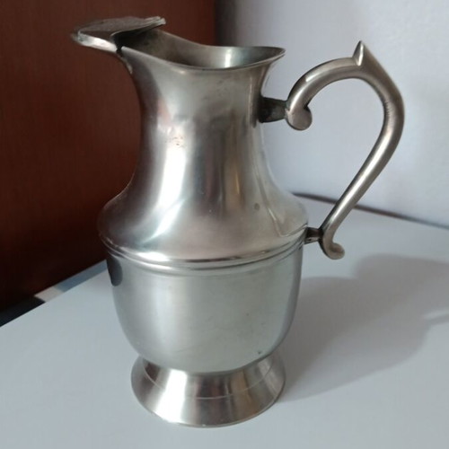 Vintage metal pitcher used with hinged lid and embossed handle
