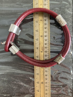 Leather cord bracelet with silver-tone metal accents