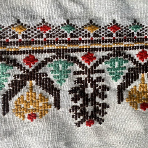 Woven fabric on loom new, thin cream wool textile with embroidery