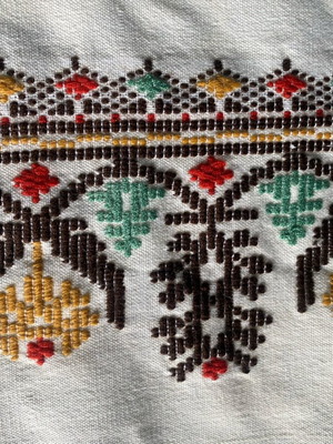 Woven fabric on loom new, thin cream wool textile with embroidery