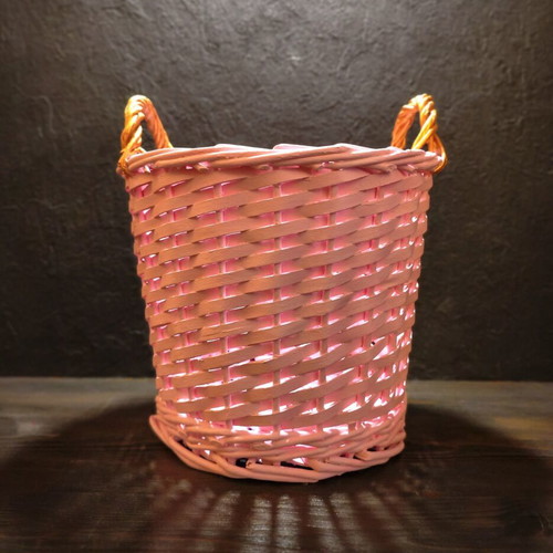 Decorative pink rattan basket with gold handles, handmade