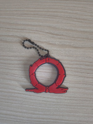 God of War keychain like new, black and red