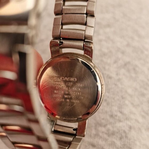 Casio women's watch used with black dial and metal bracelet