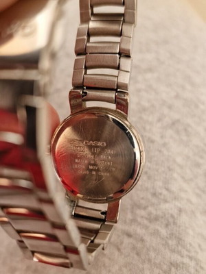 Casio women's watch used with black dial and metal bracelet