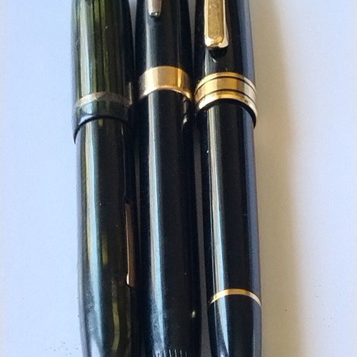Sheaffer's vintage fountain pen set with 14K gold nibs and desk base, used