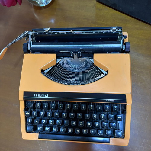 Vintage Trend Typewriter used with ribbon and case, orange color