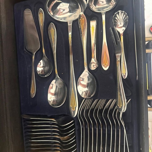 Cutlery set like new with knives, forks, spoons, and kitchen accessories