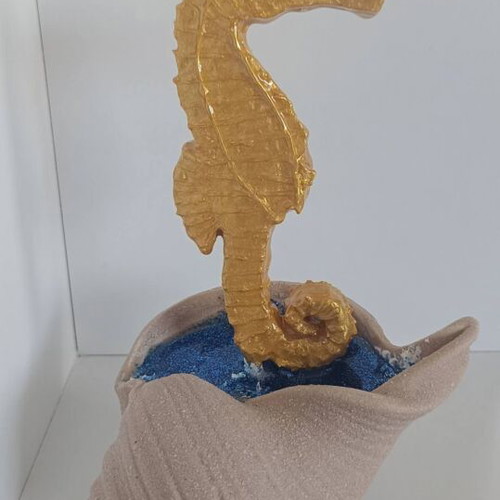 Handmade decorative gold seahorse from clay and resin with brown shell base