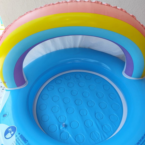 Blue children's pool with canopy used, rainbow design