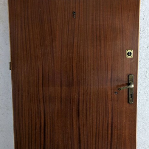 Wooden door used with double lock and peephole