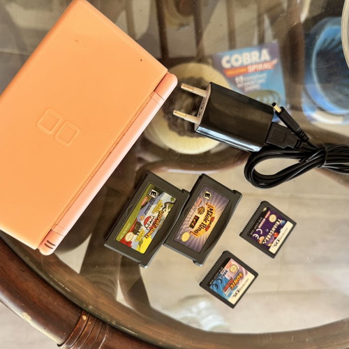 Nintendo DS used with 5 game cartridges and charger