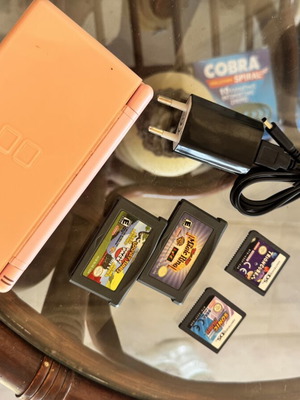Nintendo DS used with 5 game cartridges and charger