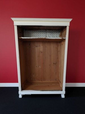 Open wooden wardrobe used, white frame with natural wood interior