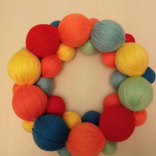 Decorative wreath used made of colorful wool yarn balls