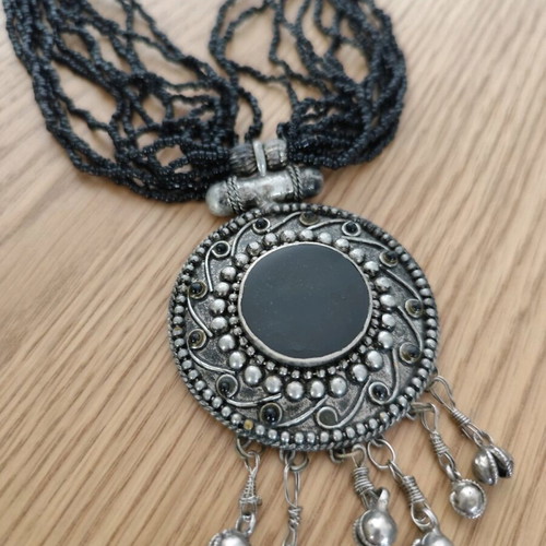 Long necklace with round pendant and bells, like new