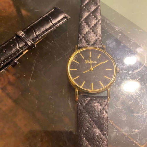 Geneva watch used with black quilted leatherette strap and gold case