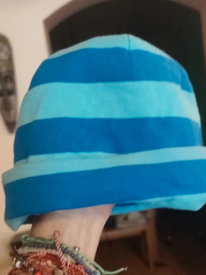 Soft cotton cap for young child used, blue and turquoise striped