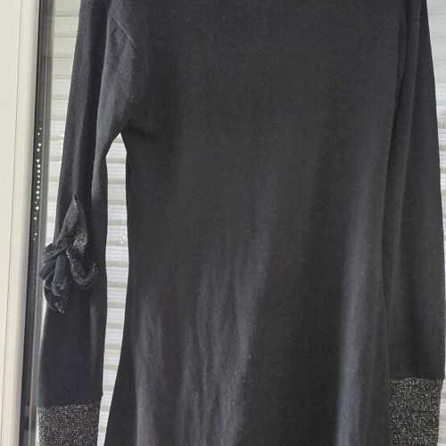 Women's black knitted winter dress with silver details and flower