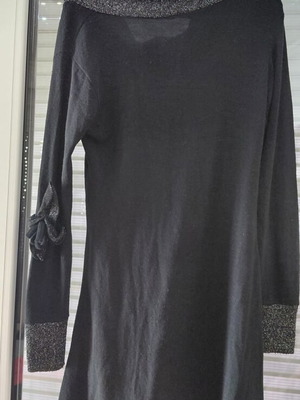 Women's black knitted winter dress with silver details and flower