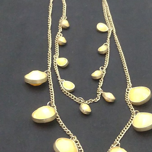 Double long necklace with matte gold chain and beige decorations