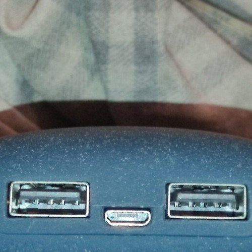 Powerbank with two USB ports used, includes two cables