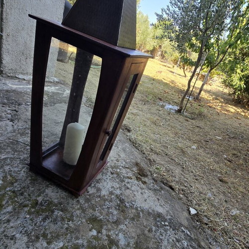 Decorative wooden lantern with metal roof and chimney