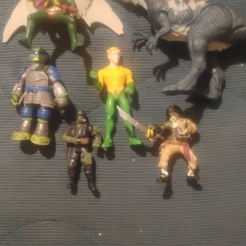 Lot of assorted action figures and dinosaur toy