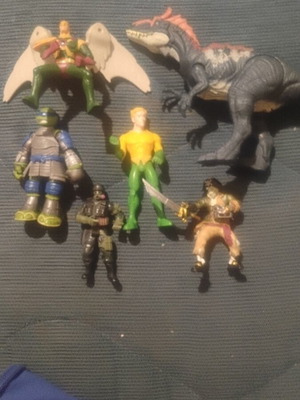 Lot of assorted action figures and dinosaur toy