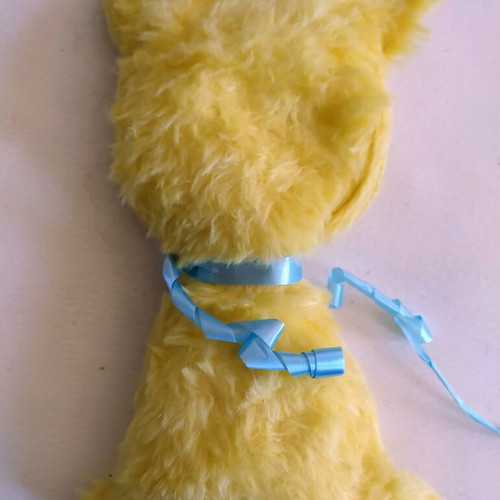 Vintage Greek plush toy, yellow with blue ribbon