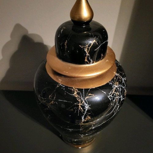 Decorative vase used with lid, black marble look and gold details