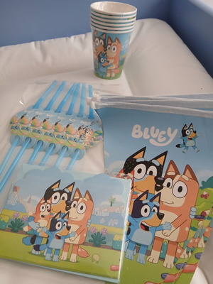Bluey birthday party set with invitations, straws, cups, knives, and banner