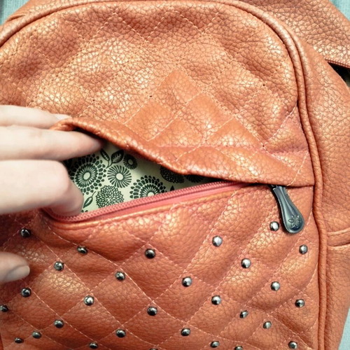 Backpack used red bag with quilted front zipper