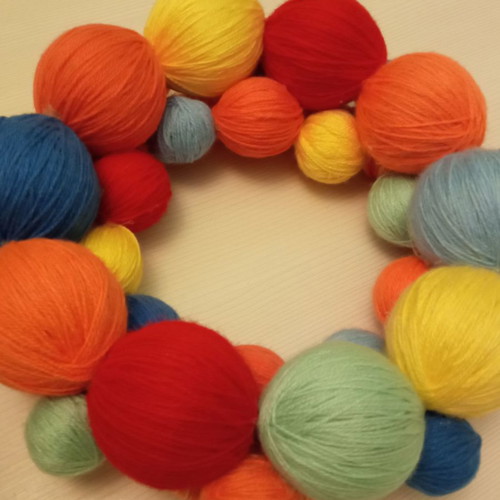 Decorative wreath used made of colorful wool yarn balls