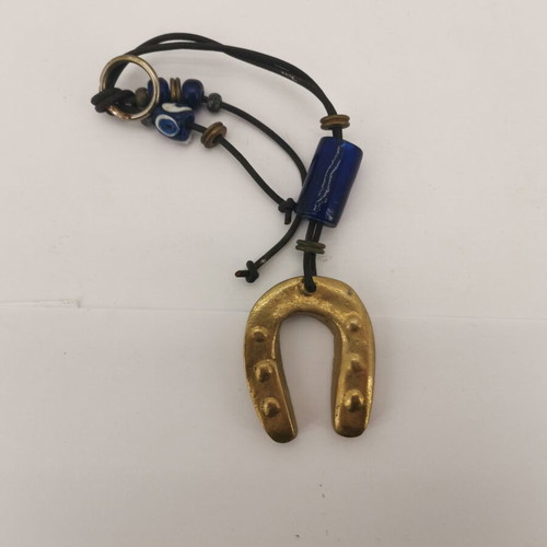 Bronze horseshoe charm used with small glass bead