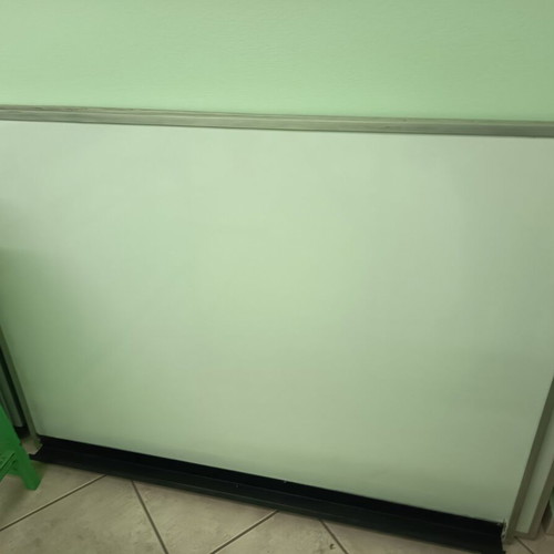 Whiteboard used for tutoring with metal frame and marker shelf
