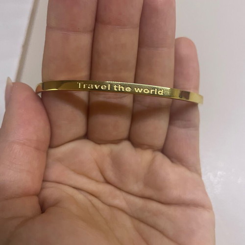 Gold-tone bracelet with travel design