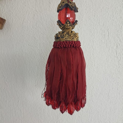 Red fabric decorative tassel used with hanging ornament gift