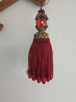 Red fabric decorative tassel used with hanging ornament gift