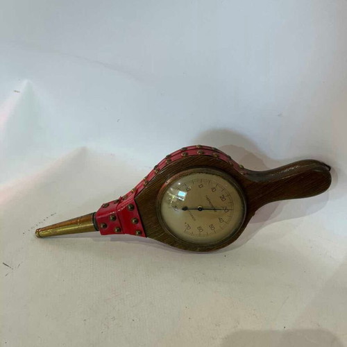 Vintage wall thermometer shaped like a fireplace bellows used