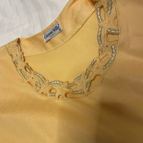 Yellow loose blouse with neckline design used