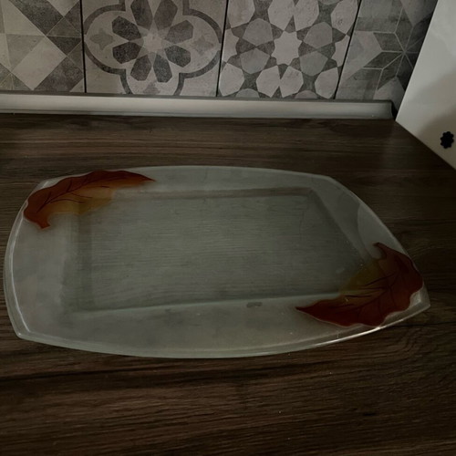 Decorative glass tray used with embossed leaf design