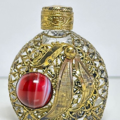 Vintage perfume flacon with filigree metalwork and red cabochon