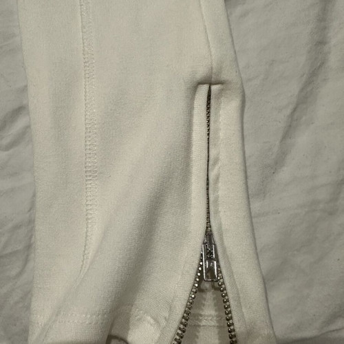 White elastic slim fit pants with ankle zippers