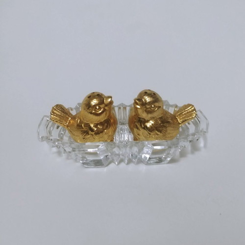 Set of gilded miniature salt and pepper shakers with lead tray