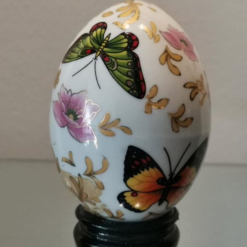 Porcelain egg used with butterflies and wooden base