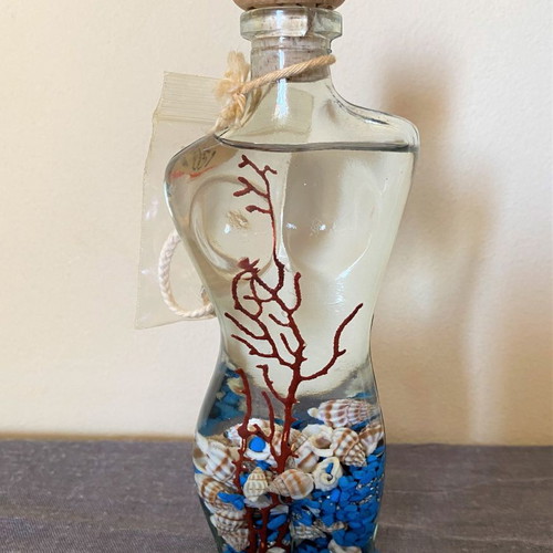 Female figure candle new with shells and stones