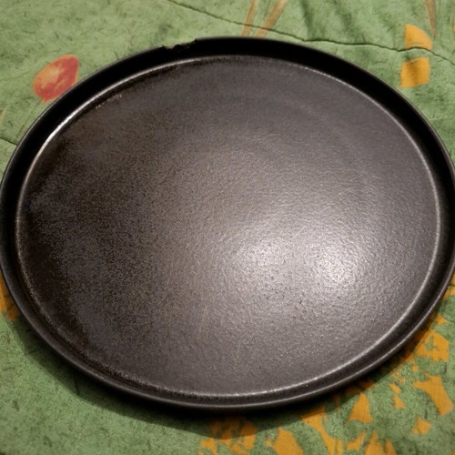 Porcelain plate used, black with small chip