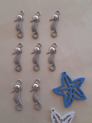 8 metal seahorse charms and 2 wooden starfish